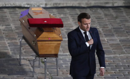 FILE - French President Emmanuel Macron leaves after paying his respects by the coffin of slain teacher Samuel Paty in the courtyard of the Sorbonne university during a national memorial event, Wednesday, Oct. 21, 2020 in Paris. (AP Photo/Francois Mori, Pool, File)