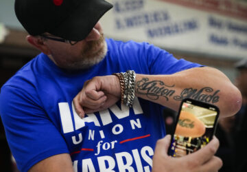 Ed Lutgen shows off his tattoo while waiting to hear the results of the union vote on a new contract offer from Boeing, Monday, Nov. 4, 2024, at IAM District 751 Union Hall in Seattle. (AP Photo/Lindsey Wasson)