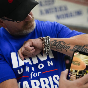 Ed Lutgen shows off his tattoo while waiting to hear the results of the union vote on a new contract offer from Boeing, Monday, Nov. 4, 2024, at IAM District 751 Union Hall in Seattle. (AP Photo/Lindsey Wasson)