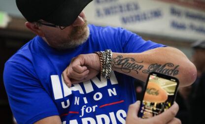 Ed Lutgen shows off his tattoo while waiting to hear the results of the union vote on a new contract offer from Boeing, Monday, Nov. 4, 2024, at IAM District 751 Union Hall in Seattle. (AP Photo/Lindsey Wasson)