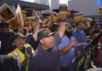 FILE - Teamsters and workers hold a rally in downtown Los Angeles, July 19, 2023, as a deadline neared in negotiations between the union and United Parcel Service. (AP Photo/Damian Dovarganes)