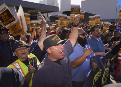 FILE - Teamsters and workers hold a rally in downtown Los Angeles, July 19, 2023, as a deadline neared in negotiations between the union and United Parcel Service. (AP Photo/Damian Dovarganes)