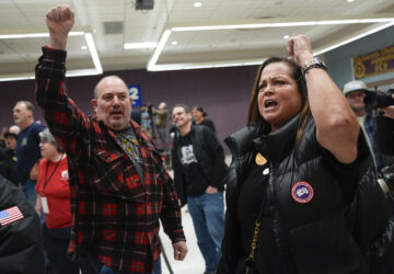 Boeing employees Harold Ruffalo, left, and Gina Forbush, right, react to the announcement that union members voted to reject a new contract offer from the company, Wednesday, Oct. 23, 2024, at Seattle Union Hall in Seattle. (AP Photo/Lindsey Wasson)