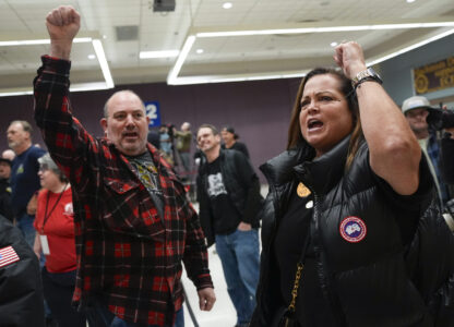 Boeing employees Harold Ruffalo, left, and Gina Forbush, right, react to the announcement that union members voted to reject a new contract offer from the company, Wednesday, Oct. 23, 2024, at Seattle Union Hall in Seattle. (AP Photo/Lindsey Wasson)