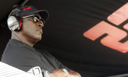 Michael Jordan, co-owner of 23XI Racing, sits in his pit box during a NASCAR Cup Series auto race at Talladega Superspeedway, Sunday, Oct. 6, 2024, in Talladega, Ala. (AP Photo/ Butch Dill)