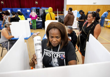 Sheron Campbell wears a Kamala Harris shirt while voting on Election Day in Oakland, Calif., Tuesday, Nov. 5, 2024. (AP Photo/Noah Berger)