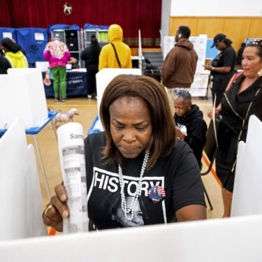 Sheron Campbell wears a Kamala Harris shirt while voting on Election Day in Oakland, Calif., Tuesday, Nov. 5, 2024. (AP Photo/Noah Berger)