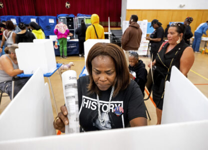 Sheron Campbell wears a Kamala Harris shirt while voting on Election Day in Oakland, Calif., Tuesday, Nov. 5, 2024. (AP Photo/Noah Berger)