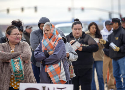 Voters wait in line to cast their ballots outside a polling station on the Navajo Nation in Chinle, Ariz., on Election Day, Tuesday, Nov. 5, 2024. (AP Photo/Andres Leighton)