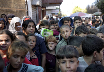 FILE - Palestinians line up for food distribution in Deir al-Balah, Gaza Strip, on Oct. 17, 2024. (AP Photo/Abdel Kareem Hana, File)