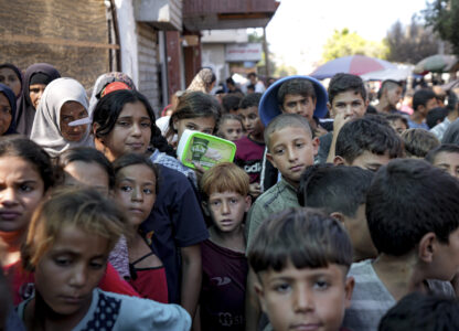 FILE - Palestinians line up for food distribution in Deir al-Balah, Gaza Strip, on Oct. 17, 2024. (AP Photo/Abdel Kareem Hana, File)