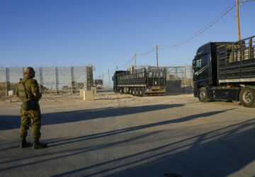 FILE - Trucks carrying humanitarian aid cross into the Gaza Strip from Erez crossing in southern Israel, on Oct. 21, 2024. (AP Photo/Tsafrir Abayov, File)