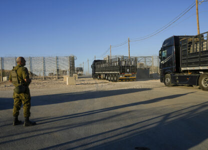 FILE - Trucks carrying humanitarian aid cross into the Gaza Strip from Erez crossing in southern Israel, on Oct. 21, 2024. (AP Photo/Tsafrir Abayov, File)