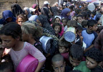 FILE - Palestinians line up for food distribution in Deir al-Balah, Gaza Strip, on Oct. 17, 2024. (AP Photo/Abdel Kareem Hana, File)