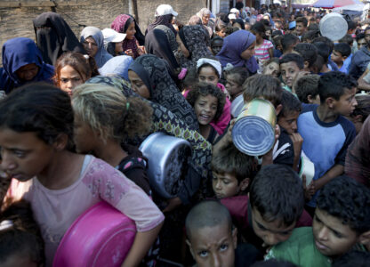 FILE - Palestinians line up for food distribution in Deir al-Balah, Gaza Strip, on Oct. 17, 2024. (AP Photo/Abdel Kareem Hana, File)