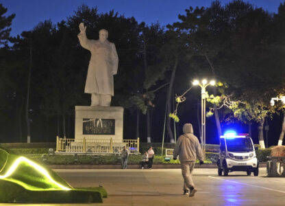 Pedestrian walks by a statue of Chairman Mao Zedong in Changchun, a city located in northwestern China's industrial rustbelt zone Jilin province on Oct. 12, 2024. (AP Photo/Dake Kang)