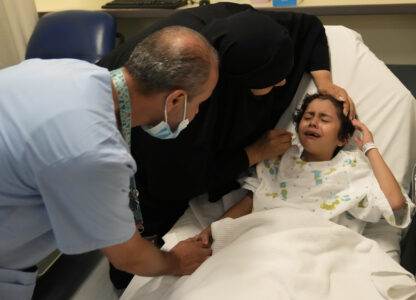 Palestinian girl Halima Abou Yassine, 7, who was brought to Lebanon from Gaza for treatment after an Israeli strike left her near death with a gaping wound in her skull, cries as she lies on a hospital bed ahead of a surgery on her head at the American University of Beirut Medical Center (AUBMC), in Beirut, Lebanon, Monday, July 15, 2024. (AP Photo/Hussein Malla)