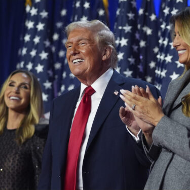 Republican presidential nominee former President Donald Trump stands on stage with former first lady Melania Trump, as Lara Trump watches, at an election night watch party at the Palm Beach Convention Center, Wednesday, Nov. 6, 2024, in West Palm Beach, Fla. (AP Photo/Evan Vucci)