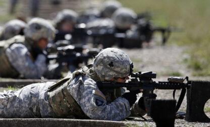 FILE - Female soldiers from 1st Brigade Combat Team, 101st Airborne Division train on a firing range while testing new body armor in Fort Campbell, Ky., Sept. 18, 2012. (AP Photo/Mark Humphrey, File)