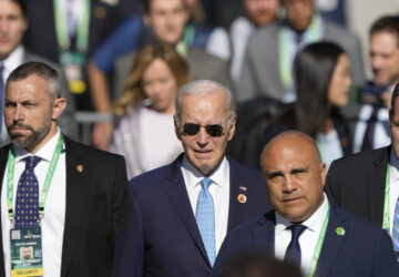 U.S. President Joe Biden arrives late for the group photo during the G20 Summit in Rio de Janeiro, Monday, Nov. 18, 2024. (AP Photo/Eraldo Peres)