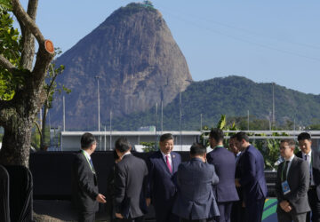 Backdropped by Sugar Loaf mountain, China's President Xi Jinping, center, walks after joining a group photo during the G20 Summit in Rio de Janeiro, Monday, Nov. 18, 2024. (AP Photo/Eraldo Peres)