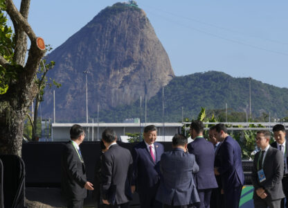 Backdropped by Sugar Loaf mountain, China's President Xi Jinping, center, walks after joining a group photo during the G20 Summit in Rio de Janeiro, Monday, Nov. 18, 2024. (AP Photo/Eraldo Peres)