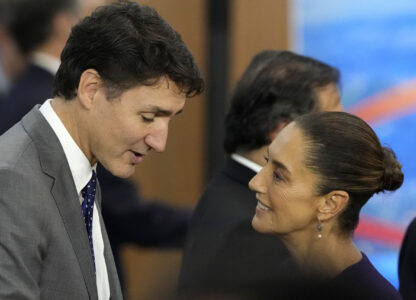 Canada's Prime Minister Justin Trudeau, left, and Mexico's President Claudia Sheinbaum talk during the G20 Summit leaders meeting in Rio de Janeiro, Monday, Nov. 18, 2024. (AP Photo/Eraldo Peres)