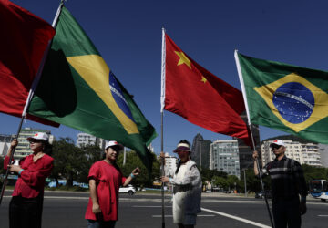 People hold Brazilian and Chinese flags during the G20 Summit in Rio de Janeiro, Monday, Nov. 18, 2024. (AP Photo/Bruna Prado)