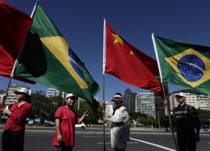 People hold Brazilian and Chinese flags during the G20 Summit in Rio de Janeiro, Monday, Nov. 18, 2024. (AP Photo/Bruna Prado)