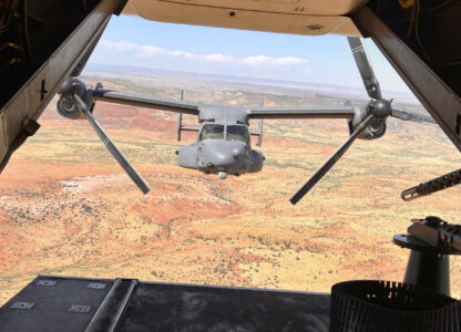 Two Air Force Special Operations Command CV-22B Ospreys fly low and fast in formation on a training range named the Hornet at Cannon Air Force Base, N.M., Oct. 9, 2024. (AP Photo/Tara Copp)