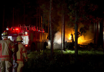 Local emergency responders extinguish the fires caused by a CV-22 Osprey crash that occurred at Eglin range June 13, 2012 near Eglin Air Force Base, Fla. (Airman 1st Class Christopher Williams, U.S. Air Force via AP)