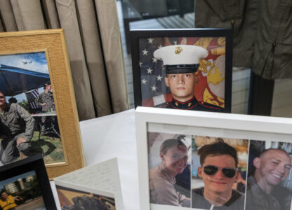 FILE - Photographs of Marine Cpl. Spencer R. Collart and his fellow marines, Capt. Eleanor V. LeBeau, bottom left, and Maj. Tobin J. Lewis, bottom right, are seen at the home of his parents in Arlington, Va., June 19, 2024. Collart, 21, was killed along with the two Marines when the MV-22B Osprey aircraft they were on crashed during drills on a north Australian island on Aug. 27, 2023. (AP Photo/Rod Lamkey, Jr.)