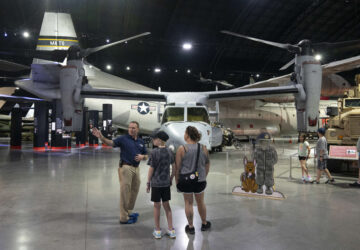 Former Air Force Osprey pilot Brian Luce, left, speaks with museum visitors inside of the Wright Patterson AFB Air Force Museum, Aug. 9, 2024, in Dayton, Ohio. (AP Photo/Jeff Dean)