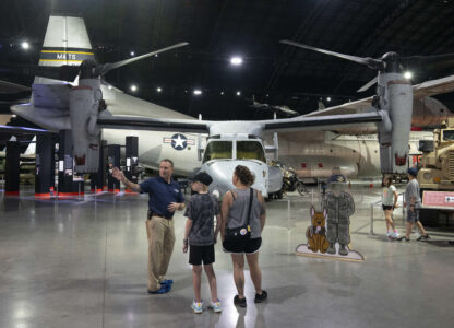 Former Air Force Osprey pilot Brian Luce, left, speaks with museum visitors inside of the Wright Patterson AFB Air Force Museum, Aug. 9, 2024, in Dayton, Ohio. (AP Photo/Jeff Dean)