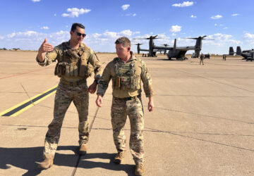 Osprey pilot Maj. Lucas Duncavage and squadron commander Lt. Col. Seth Buckley talk over their V-22 Osprey training flight just after landing, at Cannon Air Force Base, N.M., Oct. 9, 2024. During the flight they sped 100 feet off the ground on a training range named the Hornet. (AP Photo/Tara Copp)