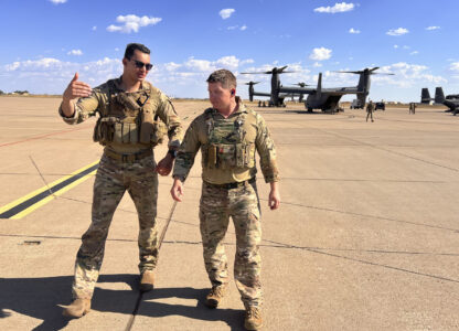 Osprey pilot Maj. Lucas Duncavage and squadron commander Lt. Col. Seth Buckley talk over their V-22 Osprey training flight just after landing, at Cannon Air Force Base, N.M., Oct. 9, 2024. During the flight they sped 100 feet off the ground on a training range named the Hornet. (AP Photo/Tara Copp)