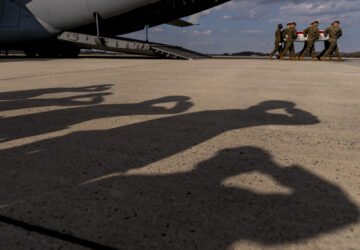 FILE - A U.S. Marine Corps carry team moves a transfer case containing the remains of Gunnery Sgt. James W. Speedy of Cambridge, Ohio, during a casualty return, Friday, March 25, 2022, at Dover Air Force Base. According to the Department of Defense, Speedy died March 18, in an Osprey crash during a NATO exercise in Norway. (AP Photo/Andrew Harnik)