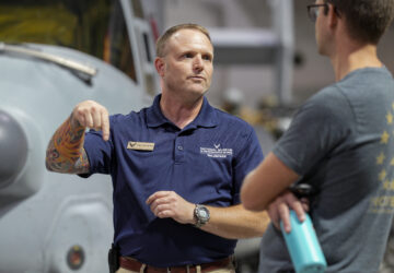 Brian Luce, left, speaks with museum visitor Ben Perkins inside of the Wright Patterson AFB Air Force Museum, Friday, Aug. 9, 2024, in Dayton, Ohio. (AP Photo/Jeff Dean)