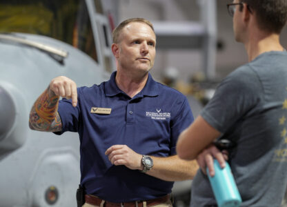 Brian Luce, left, speaks with museum visitor Ben Perkins inside of the Wright Patterson AFB Air Force Museum, Friday, Aug. 9, 2024, in Dayton, Ohio. (AP Photo/Jeff Dean)