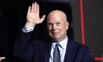 FILE - Former acting Attorney General Matt Whitaker waves as Republican presidential candidate former President Donald Trump speaks at a caucus night party in Des Moines, Iowa, Jan. 15, 2024. (AP Photo/Andrew Harnik, File)