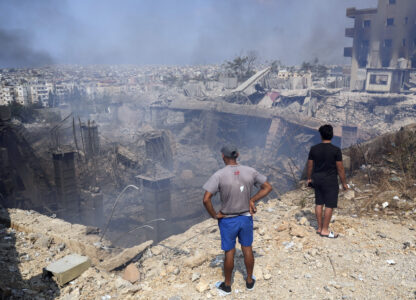 FILE - People check a damaged building at the site of an Israeli airstrike in Choueifat, south east of Beirut, on Sept. 28, 2024. (AP Photo/Hussein Malla, File)