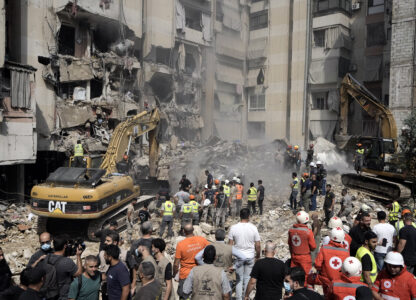 FILE - Emergency workers use excavators to clear the rubble at the site of an Israeli strike in Beirut's southern suburbs, on Sept. 21, 2024. (AP Photo/Bilal Hussein, File)