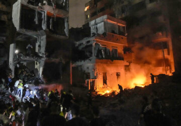 FILE - People gather in front of buildings hit by an Israeli airstrike in central Beirut, Lebanon, on Oct. 10, 2024. (AP Photo/Bilal Hussein, File)