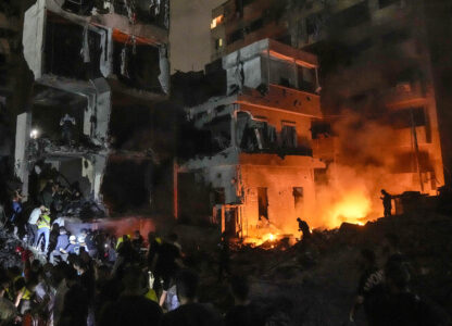 FILE - People gather in front of buildings hit by an Israeli airstrike in central Beirut, Lebanon, on Oct. 10, 2024. (AP Photo/Bilal Hussein, File)