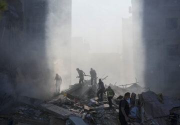 FILE - Civil defense workers extinguish a fire as smoke rises from the site of an Israeli airstrike in Tayouneh, Beirut, Lebanon, on Nov. 15, 2024. (AP Photo/Hassan Ammar, File)