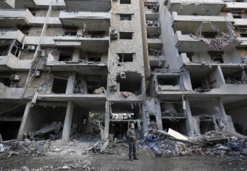 A man stands in front of a destroyed building after Sunday's Israeli airstrike in Dahiyeh, in the southern suburb of Beirut, Lebanon, Monday, Nov. 25, 2024. (AP Photo/Hussein Malla)