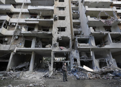 A man stands in front of a destroyed building after Sunday's Israeli airstrike in Dahiyeh, in the southern suburb of Beirut, Lebanon, Monday, Nov. 25, 2024. (AP Photo/Hussein Malla)