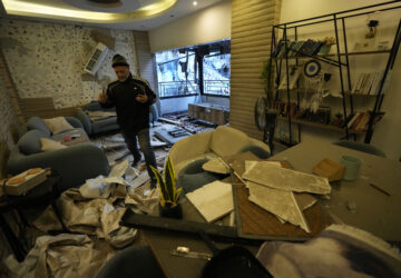 A man checks his damaged apartment which was resulted from Sunday's Israeli airstrike in Dahiyeh, in the southern suburb of Beirut, Lebanon, Monday, Nov. 25, 2024. (AP Photo/Hussein Malla)