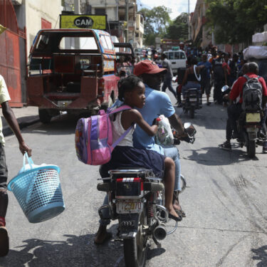 Residents flee their homes to escape gang violence in the Nazon neighborhood of Port-au-Prince, Haiti, Thursday, Nov. 14, 2024. (AP Photo/Odelyn Joseph)