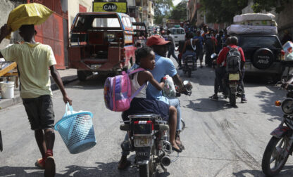 Residents flee their homes to escape gang violence in the Nazon neighborhood of Port-au-Prince, Haiti, Thursday, Nov. 14, 2024. (AP Photo/Odelyn Joseph)